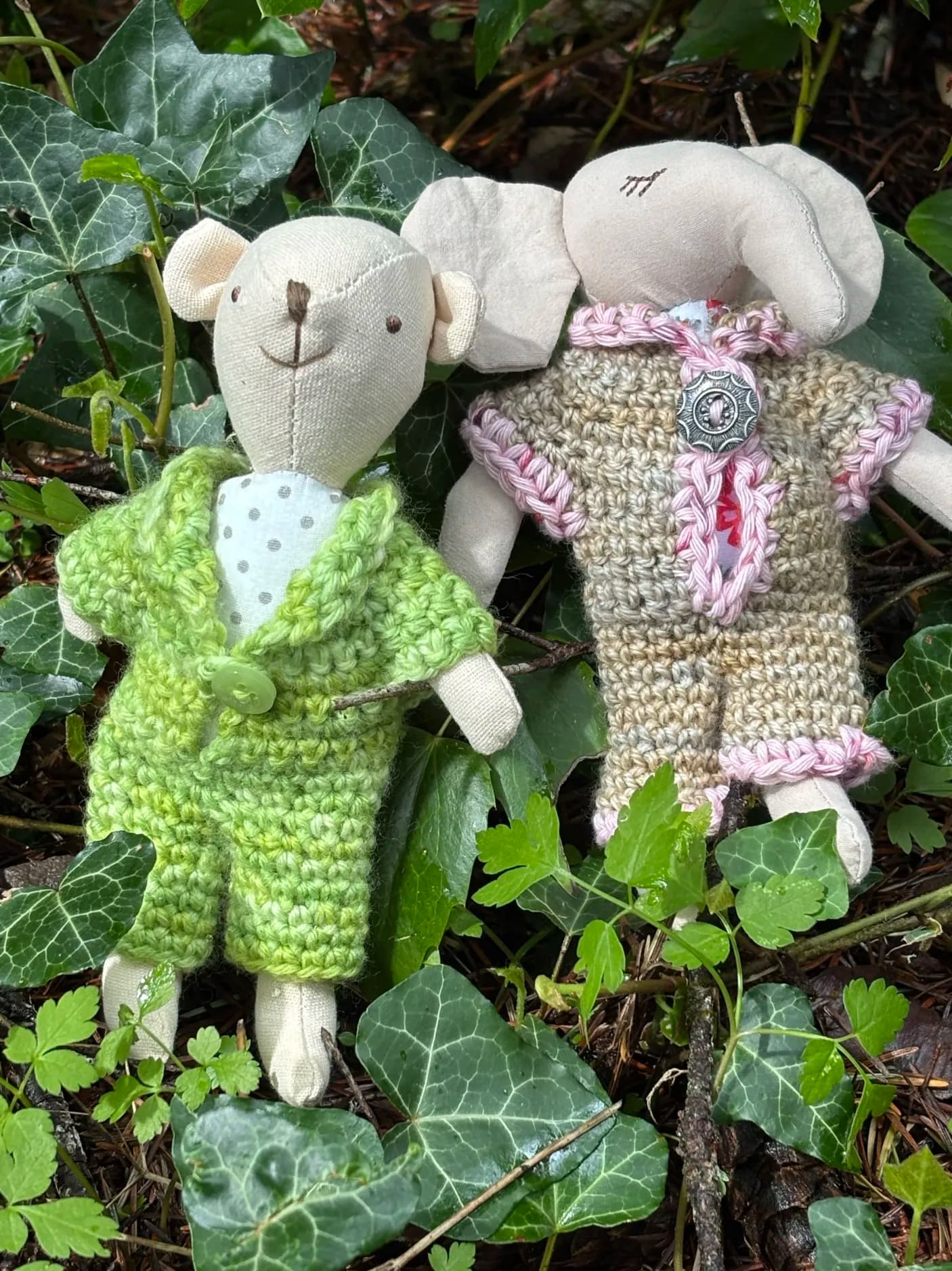 A crochet mouse and elephant in handmade outfits